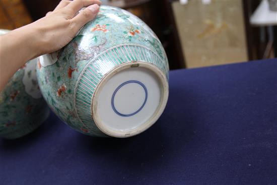 A pair of Chinese famille verte ovoid jars and covers, late 19th century, 31cm, one cover repaired